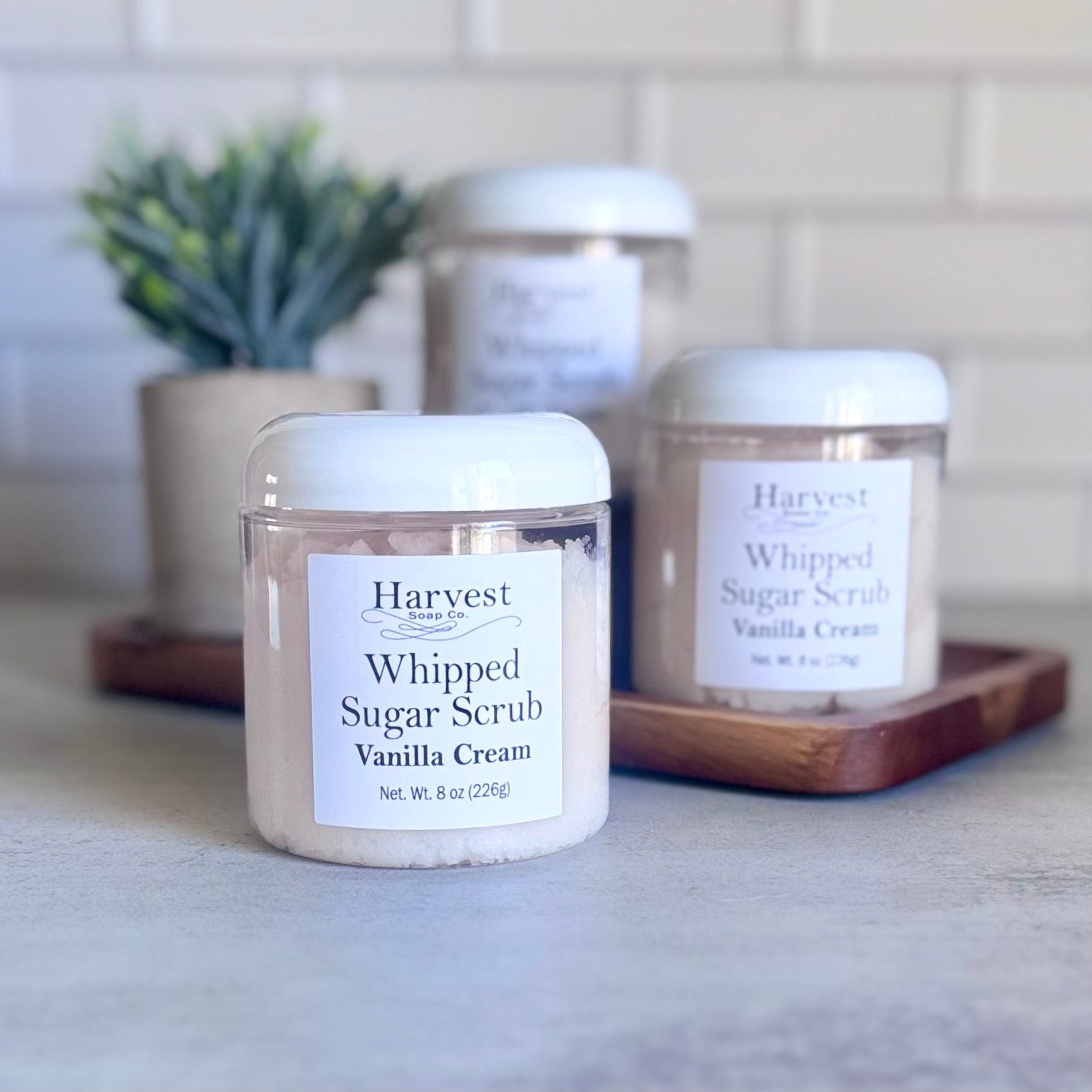 Creamy vanilla whipped sugar scrub from Harvest Soap Company with textured surface and jar of scrub visible.