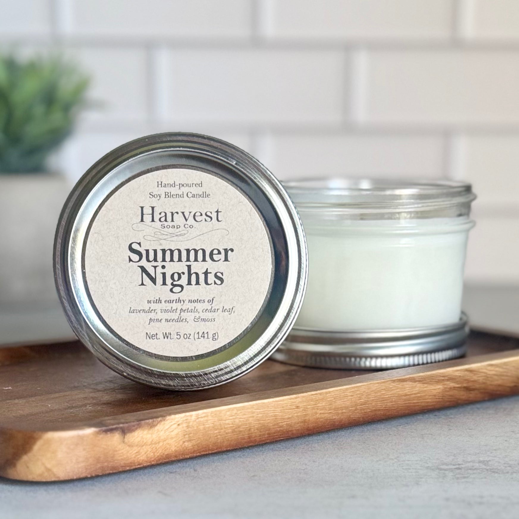 Harvest Soap Company Summer Nights Candle in a glass jar, showcasing a warm, inviting candle with a flickering flame.