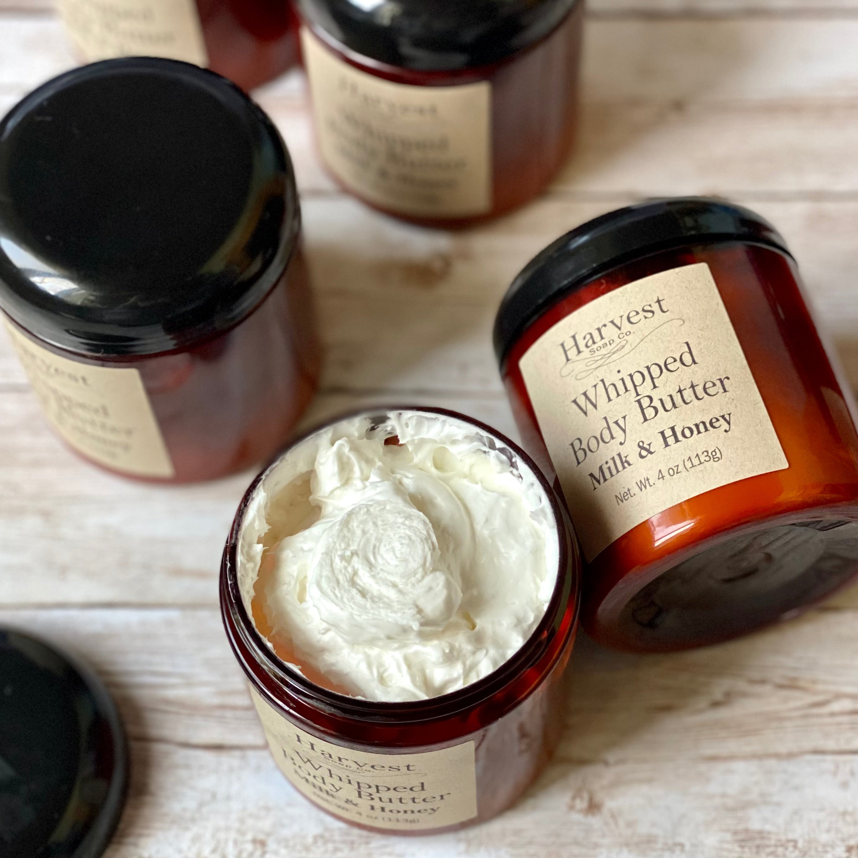 Open jar of milk and honey scented whipped body butter by harvest soap company