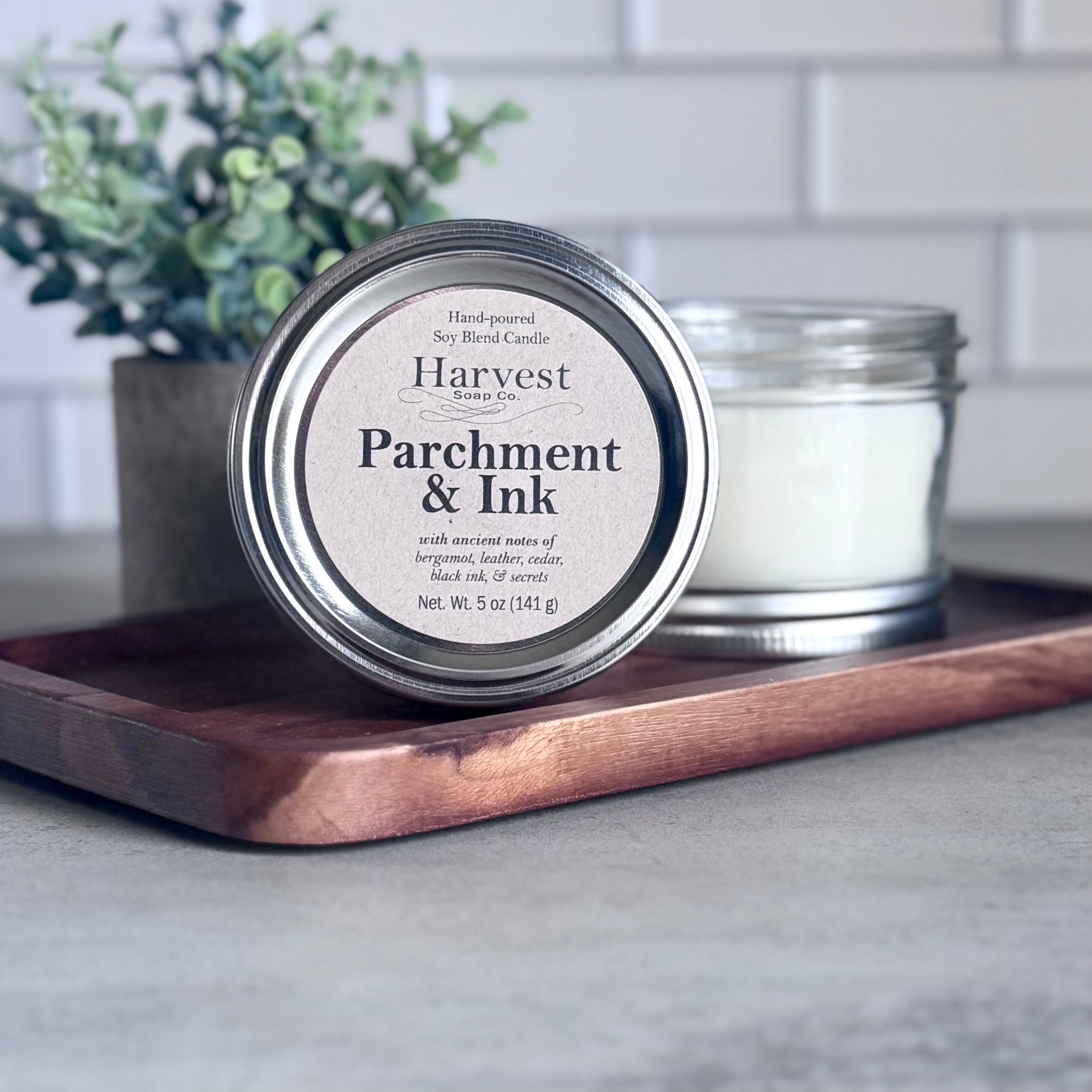 Parchment and ink-themed candle by Harvest Soap Company with a rustic design and warm, inviting glow.