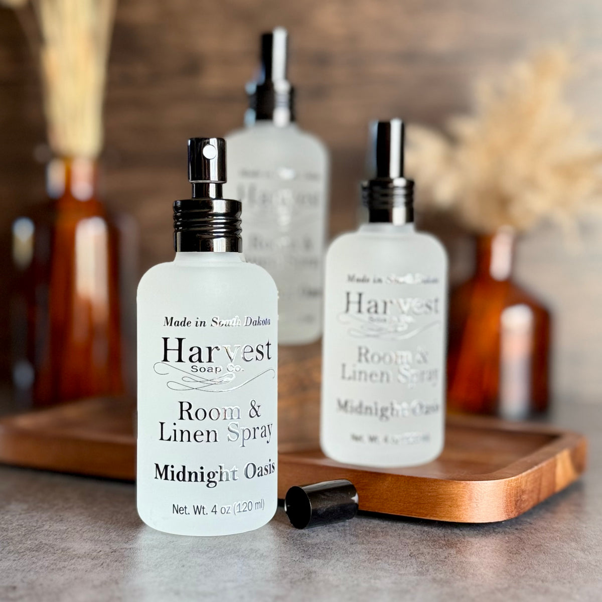 Harvest Soap Company Midnight Oasis Room and Linen Spray bottle with floral and botanical design, ready for freshening rooms and linens.