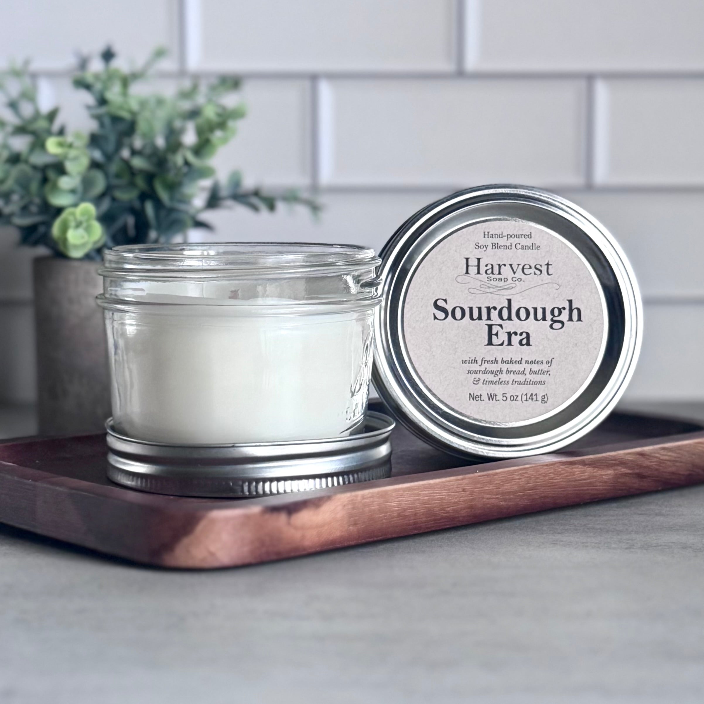 Sourdough Era Candle by Harvest Soap Company, natural soy wax candle with rustic design and warm glow, displayed on a wooden surface.