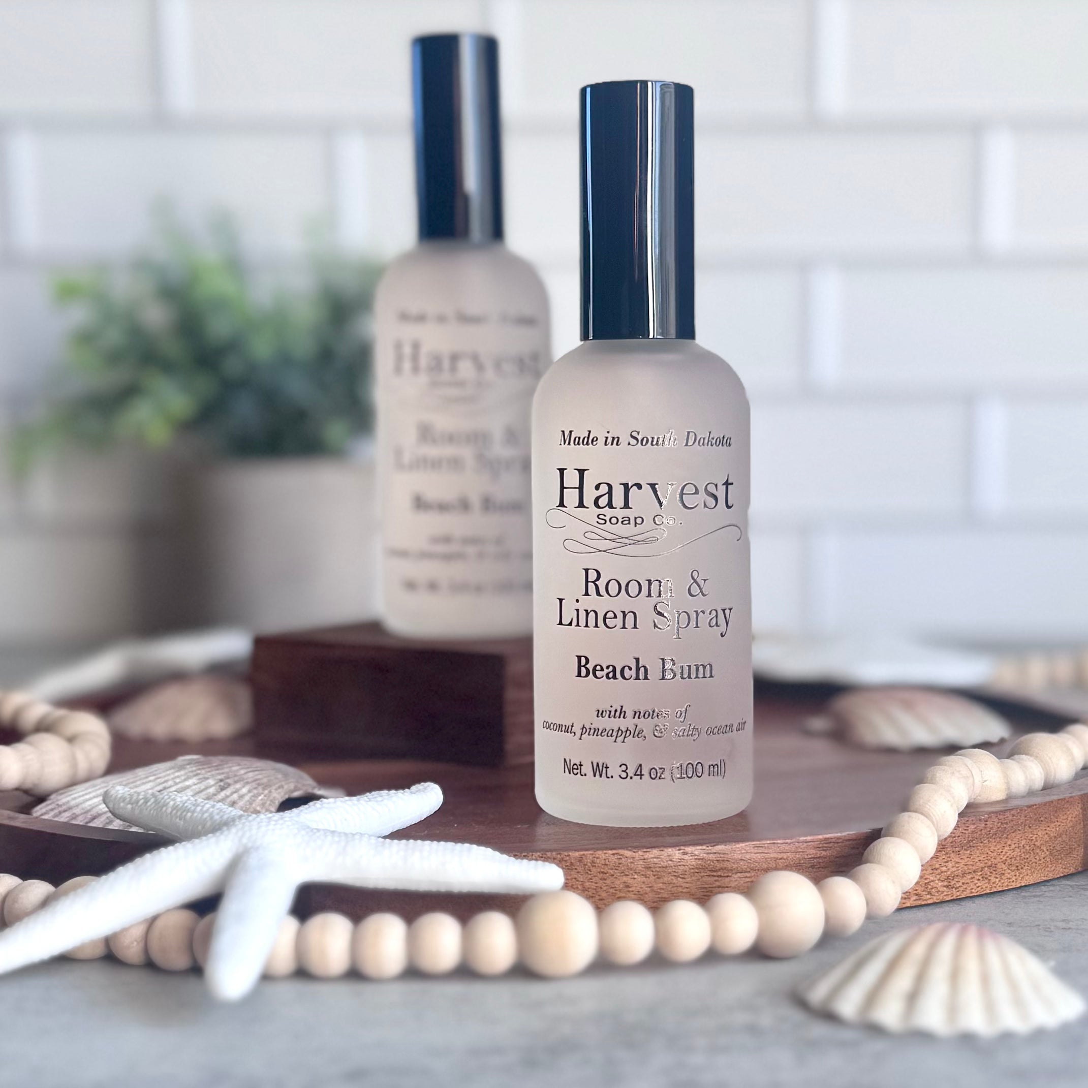 Beach Bum room and linen spray by Harvest Soap Company, clear glass bottle with a spray nozzle and a beach-inspired label.