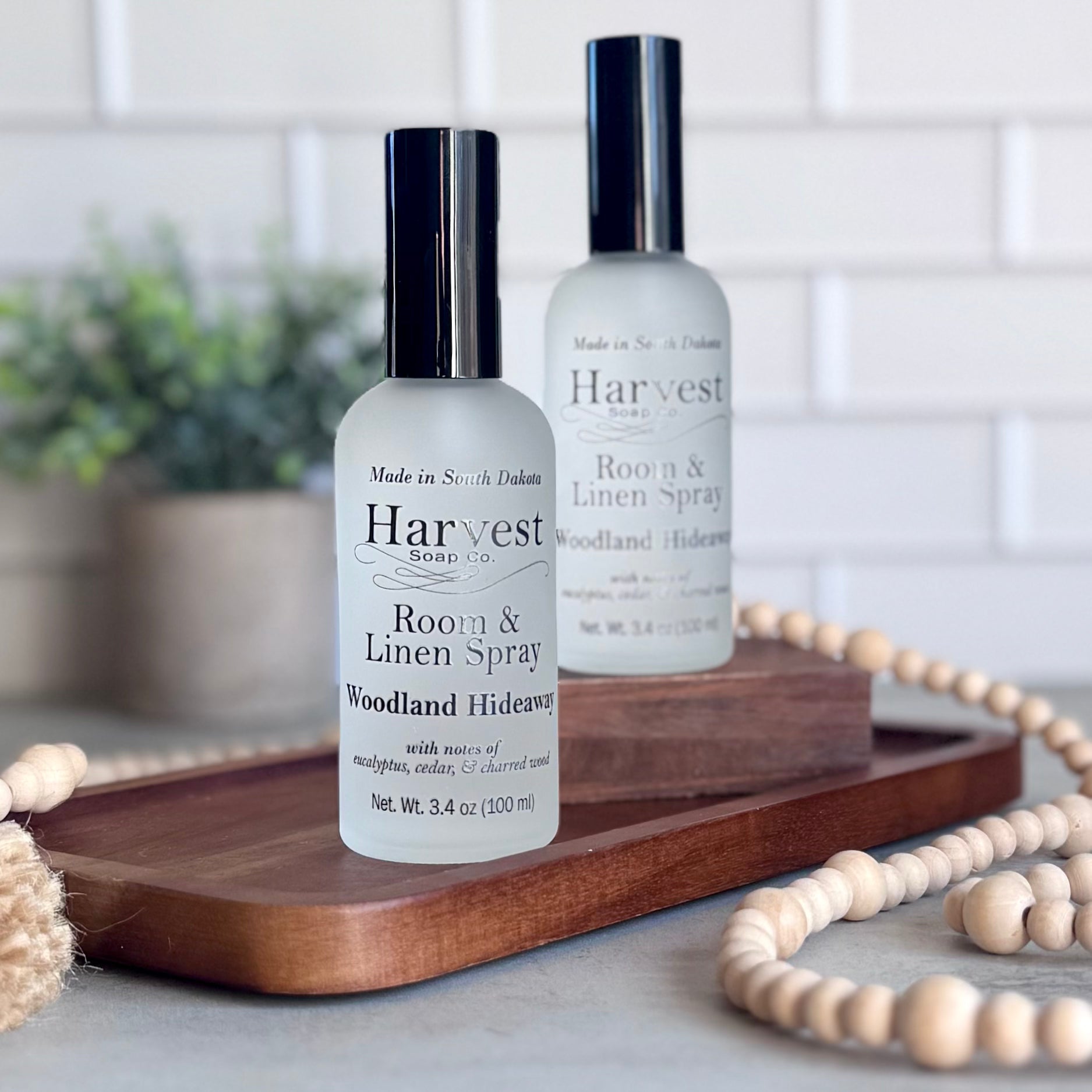 Woodland Hideaway Room and Linen Spray by Harvest Soap Company with a spray bottle and natural woodland scent theme.